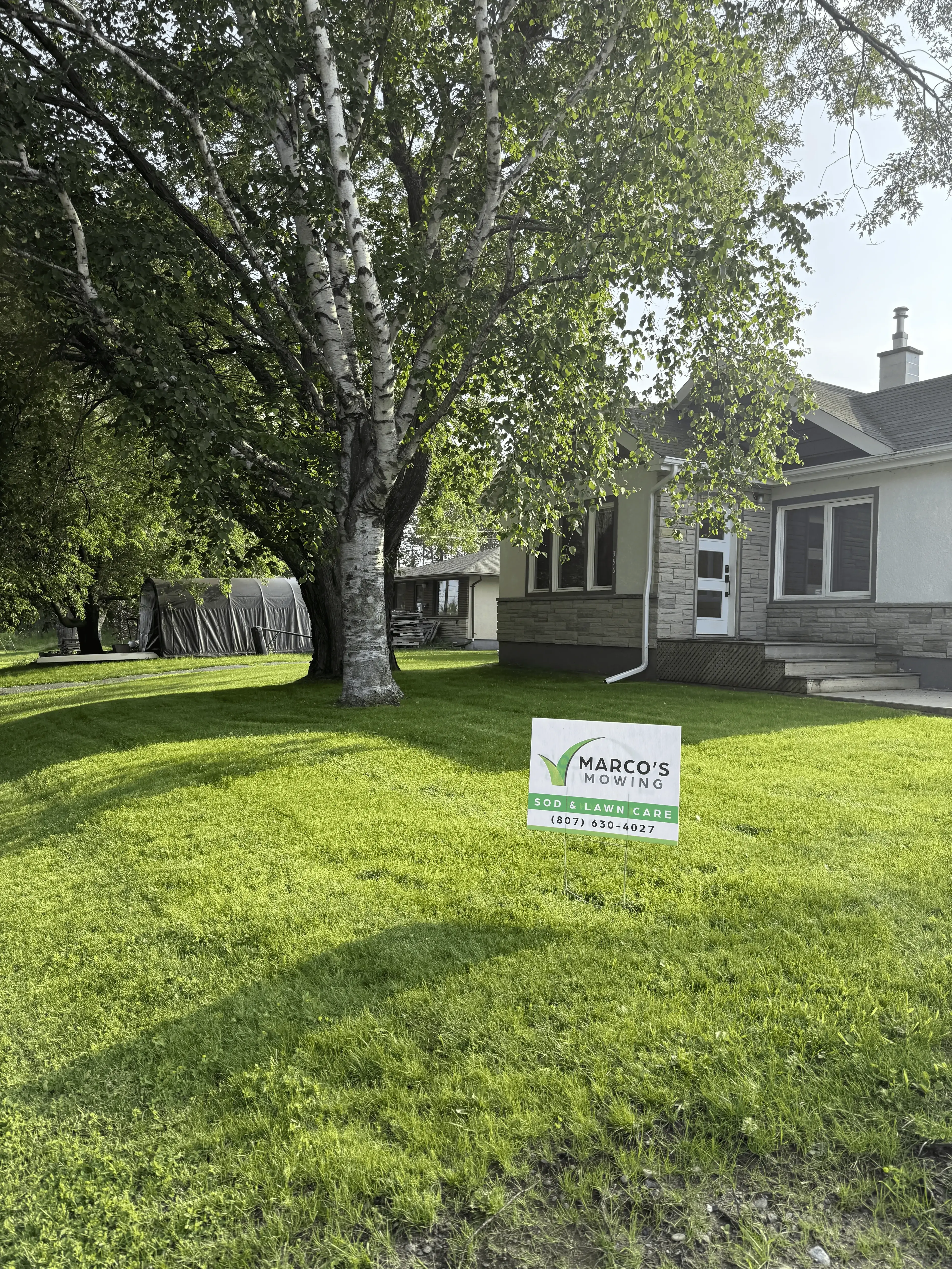 Lawn sign display of beautiful, thick, healthy green grass after program treatment